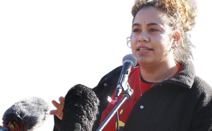 photo of Nunami, a Palawa woman, speaking into microphones.