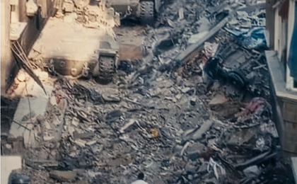 A doctor in a white coat walking through rubble
