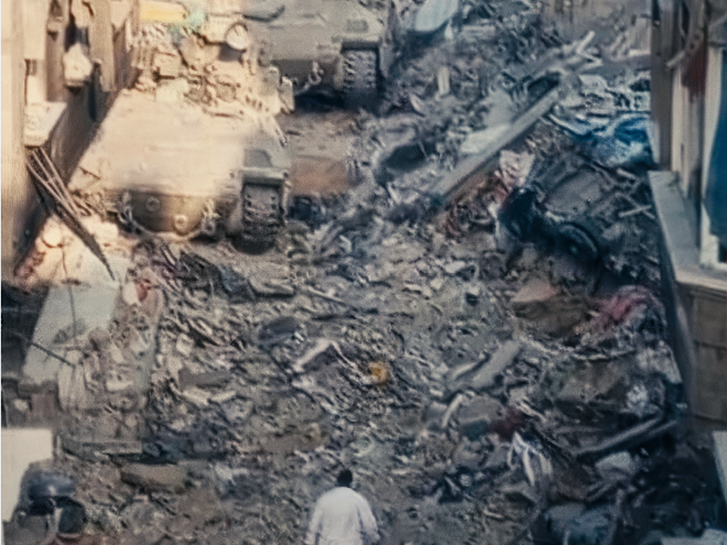 A doctor in a white coat walking through rubble