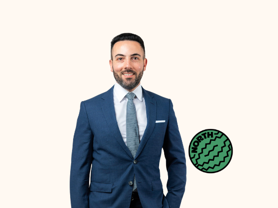 Photo of a man wearing a suit. Watermelon with the word 'North' written in it.