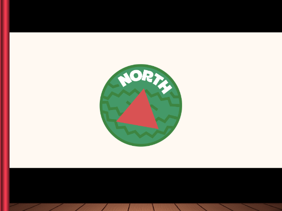 A watermelon with the word 'North' and a red triangle in the middle, displayed on a theatre screen framed by curtains.